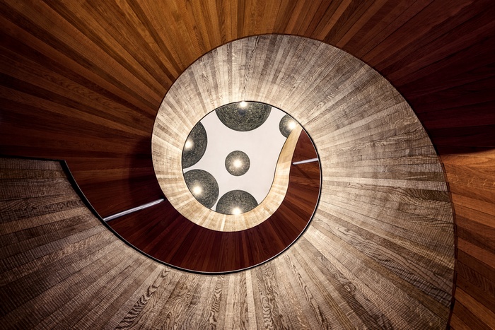 Spiral wooden staircase with pendant lights