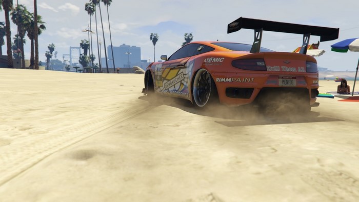 Orange sports car drifting on a beach in Grand Theft Auto V