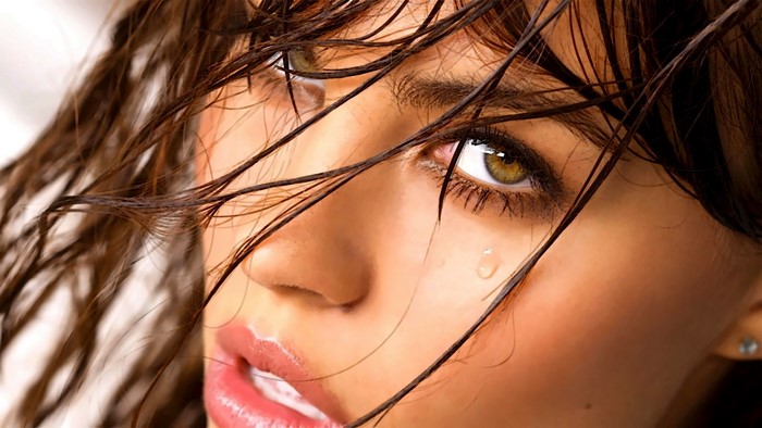Close-up of a woman's face with a tear