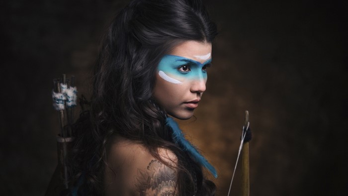 Woman with face paint and bow