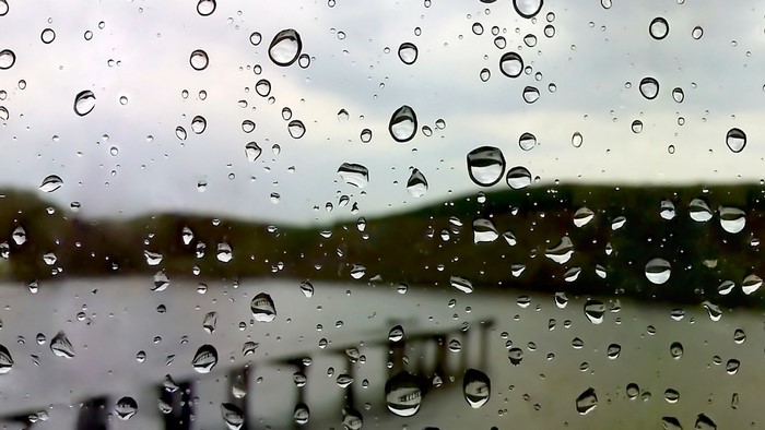 Raindrops on glass with blurred background