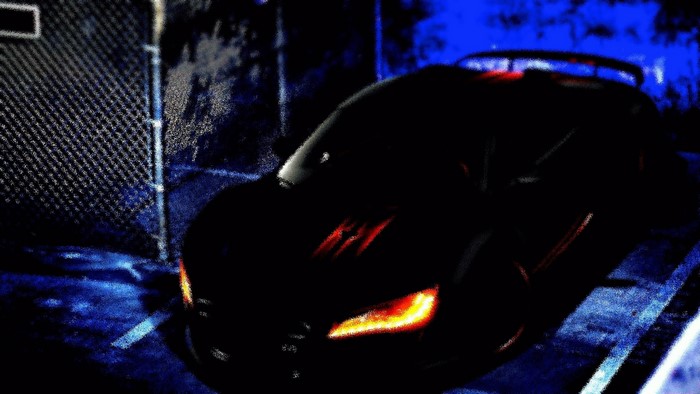 Black McLaren sports car in a dark alley