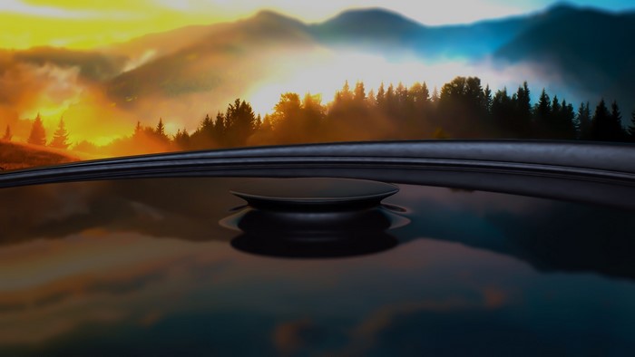 Sunrise over misty mountains and forest