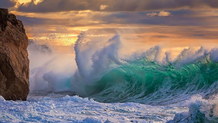 Stormy sea with crashing waves and rocky cliff