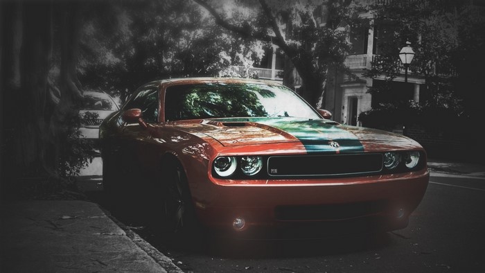 Orange Dodge Challenger SRT with racing stripes