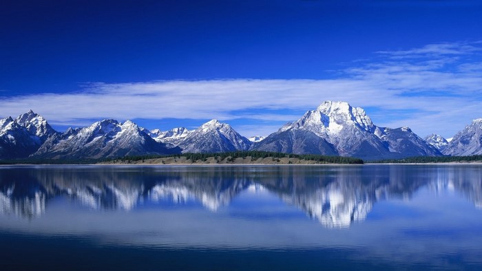 Snow-capped mountains reflected in a lake