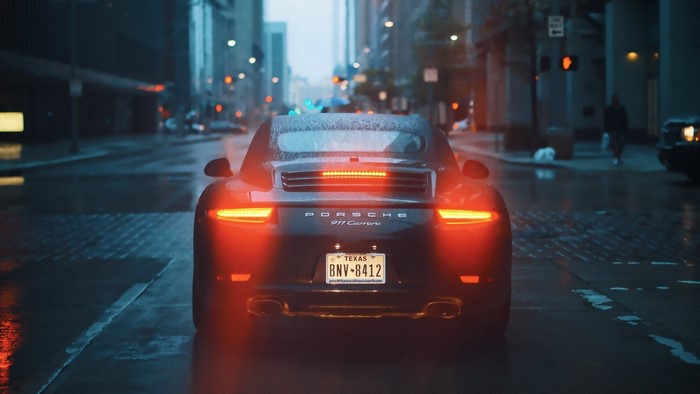 Porsche 911 Carrera on a Rainy City Street