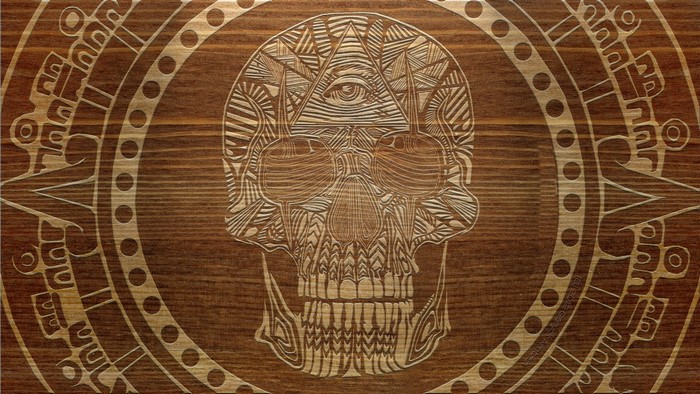Wood carving of a skull with an eye of providence