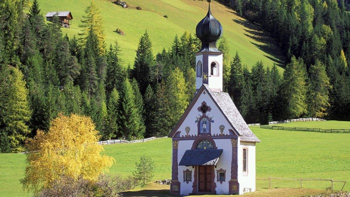 St. John's Church in a green mountain landscape