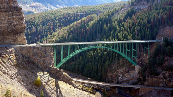 Red Cliff Bridge over a forested canyon