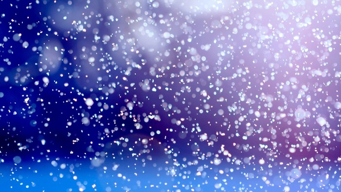 Snowflakes falling in a blue and purple gradient