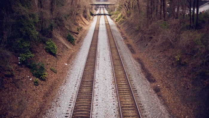 Railroad tracks through a wooded area