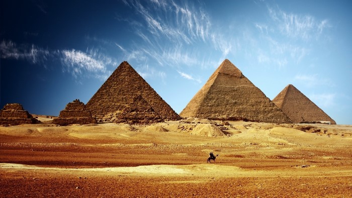Pyramids of Giza with a person on a camel