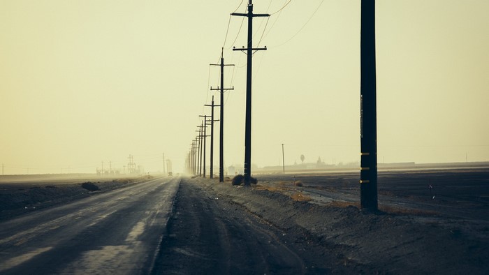 Road with electric poles in the morning