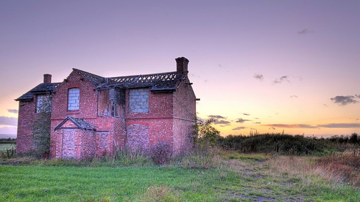 Abandoned brick building at sunset