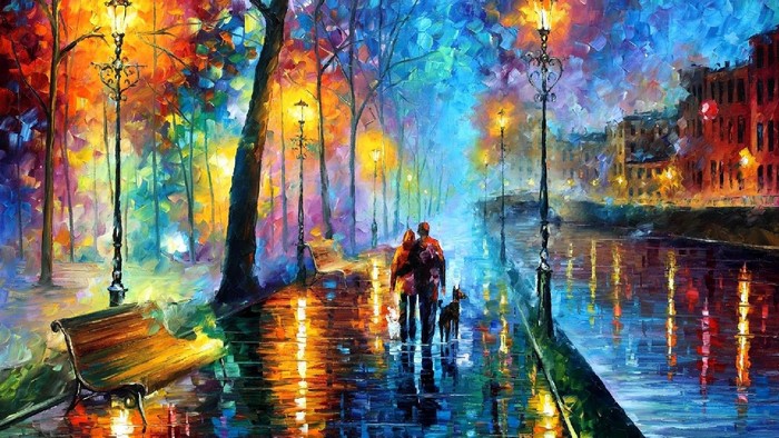 Couple walking dog on wet path with streetlights