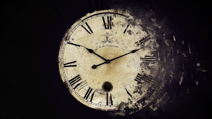 Grunge clock with Roman numerals dissolving