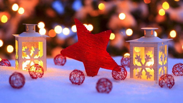 Christmas lanterns and star decoration in snow