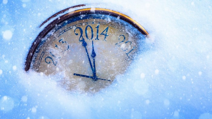 Clock covered in snow showing 2014