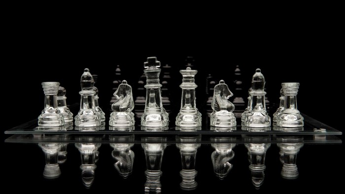 Glass Chess Set on Black Background