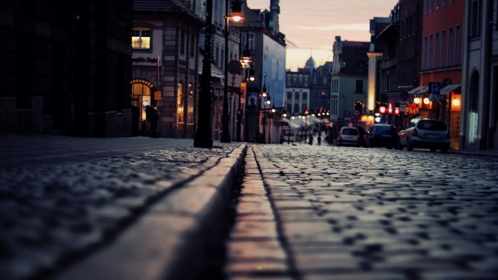 Cobblestone street in a European city at dusk