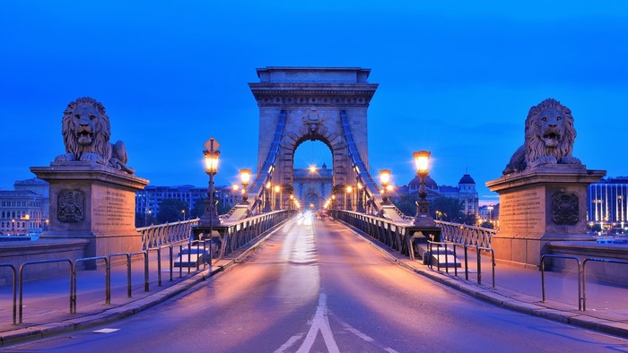 Chain bridge with lions in Budapest, Hungary at dusk