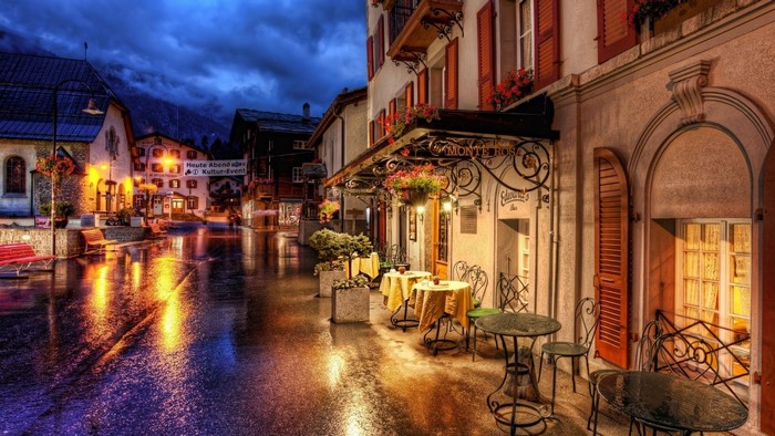 Rainy evening in a European village with outdoor cafe