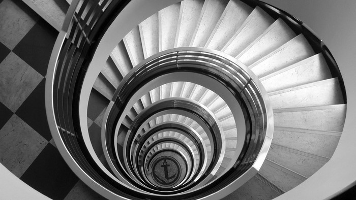 Monochrome spiral staircase with anchor emblem