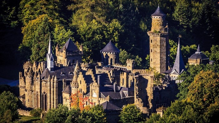 Stone castle nestled in a dense forest