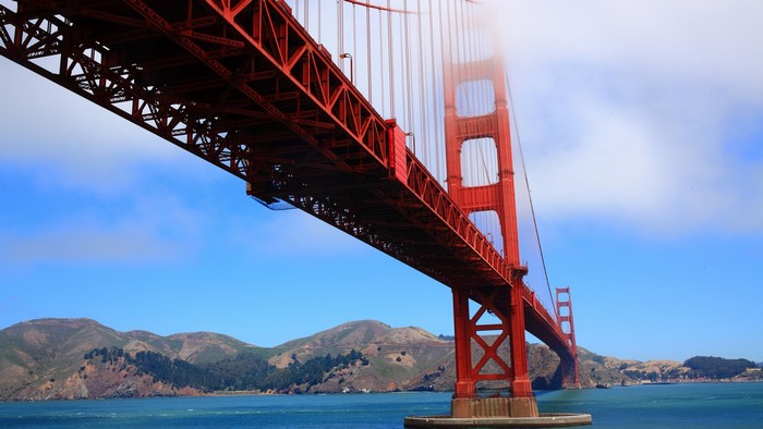 Golden Gate Bridge over water with hills