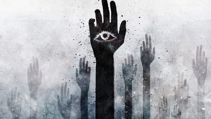 Hands raised with an eye on one hand