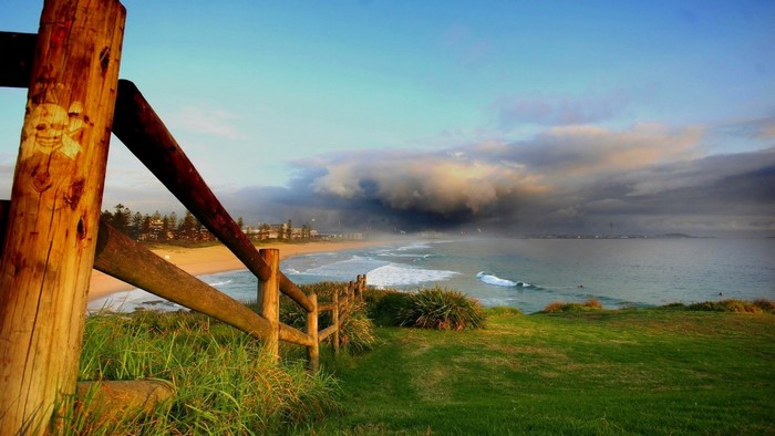 Stormy Coastline with Wooden Fence and Beach
