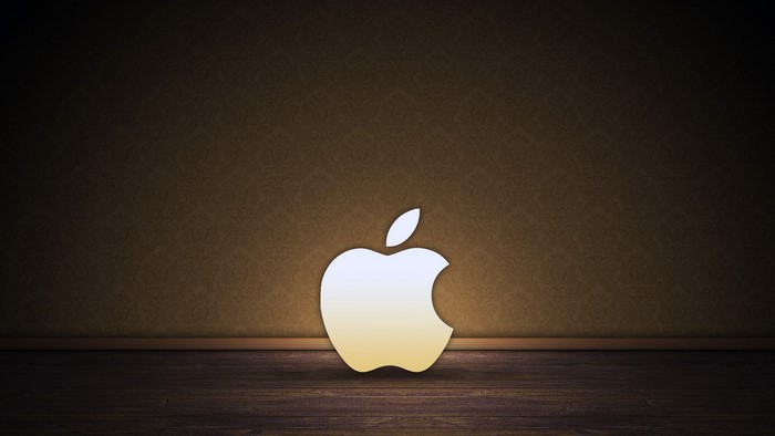 Apple logo on a textured wall and wooden floor