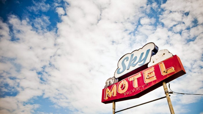 Sky Motel sign with clouds