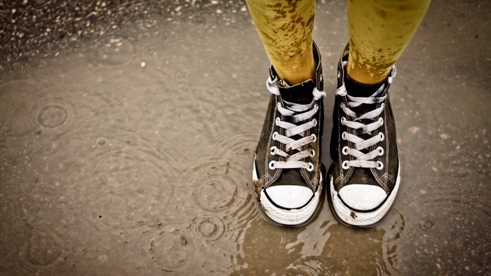 Converse sneakers in a puddle