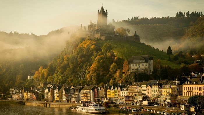 Castle on a hill above a river village