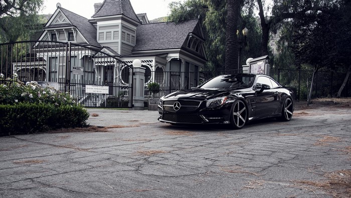 Black Mercedes SL Vossen parked near a Victorian house
