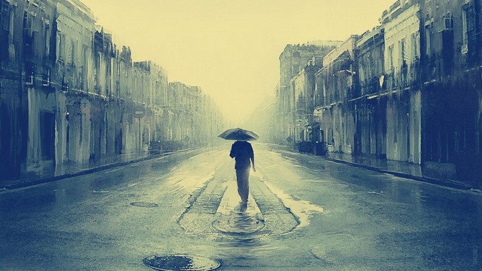 Man with umbrella walking on rainy street