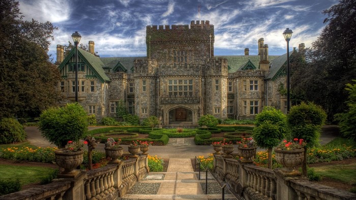 Castle with manicured gardens and cloudy sky
