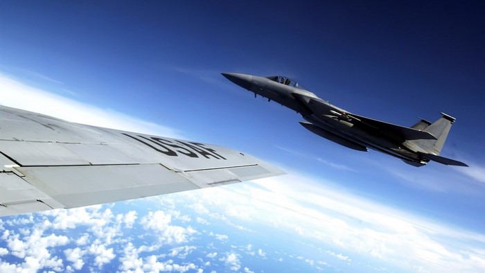 USAF F-15 Eagle in flight over clouds