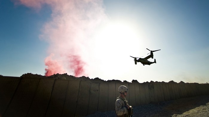 US Marine Corps Osprey and soldier with red smoke