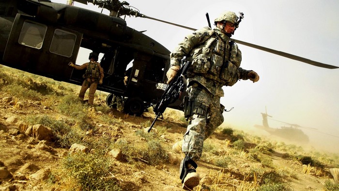 US Army soldiers disembarking from a helicopter