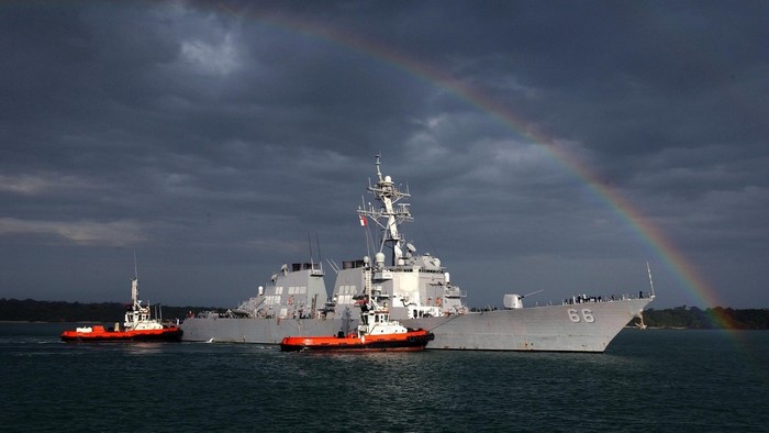 US Navy Destroyer USS Gridley (DDG-66) with tugboats under rainbow