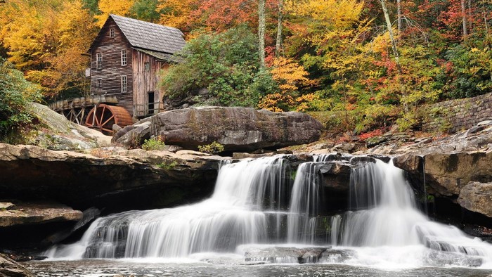 Old Timber Mill with Waterfall in Autumn