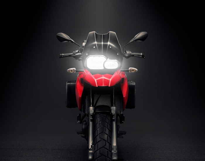 Red BMW Motorcycle with Headlights On