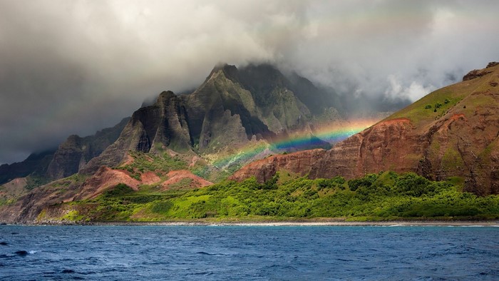 Rainbow over Na Pali Coast mountains