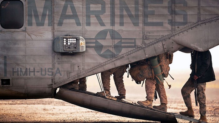 Marines boarding a HMH-USA helicopter