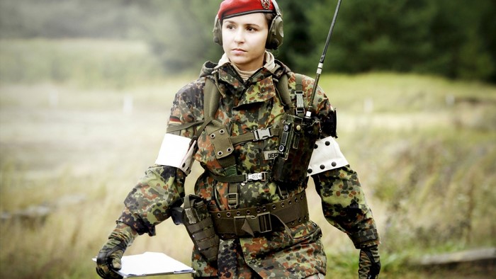 Soldier with radio equipment in camouflage uniform