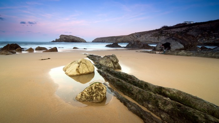 Beach with rocks and ocean at sunset
