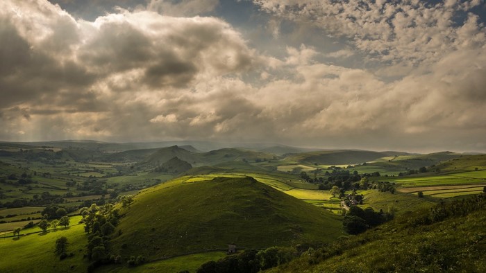 Green rolling hills and dramatic clouds in the UK